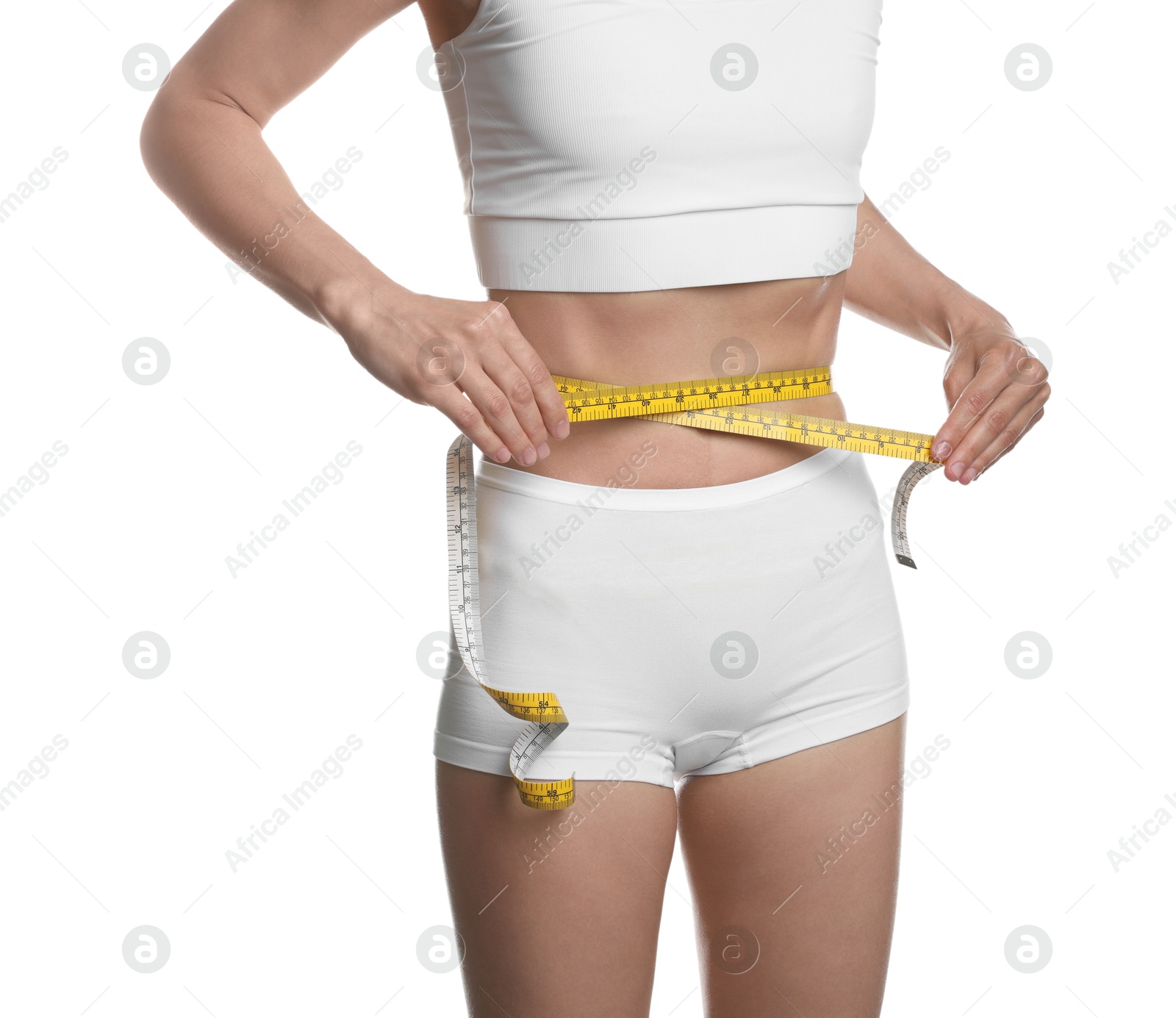 Anorexic woman measuring her waist on white background, closeup Photo of Anorexic woman measuring her waist on white background, closeup