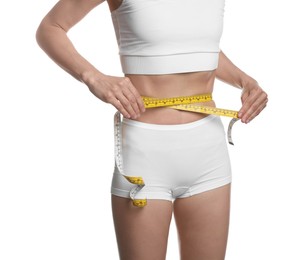 Photo of Anorexic woman measuring her waist on white background, closeup