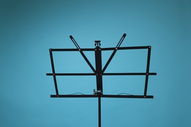 Photo of One empty note stand on light blue background