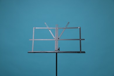 Photo of One empty note stand on light blue background