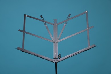 Photo of One empty note stand on light blue background