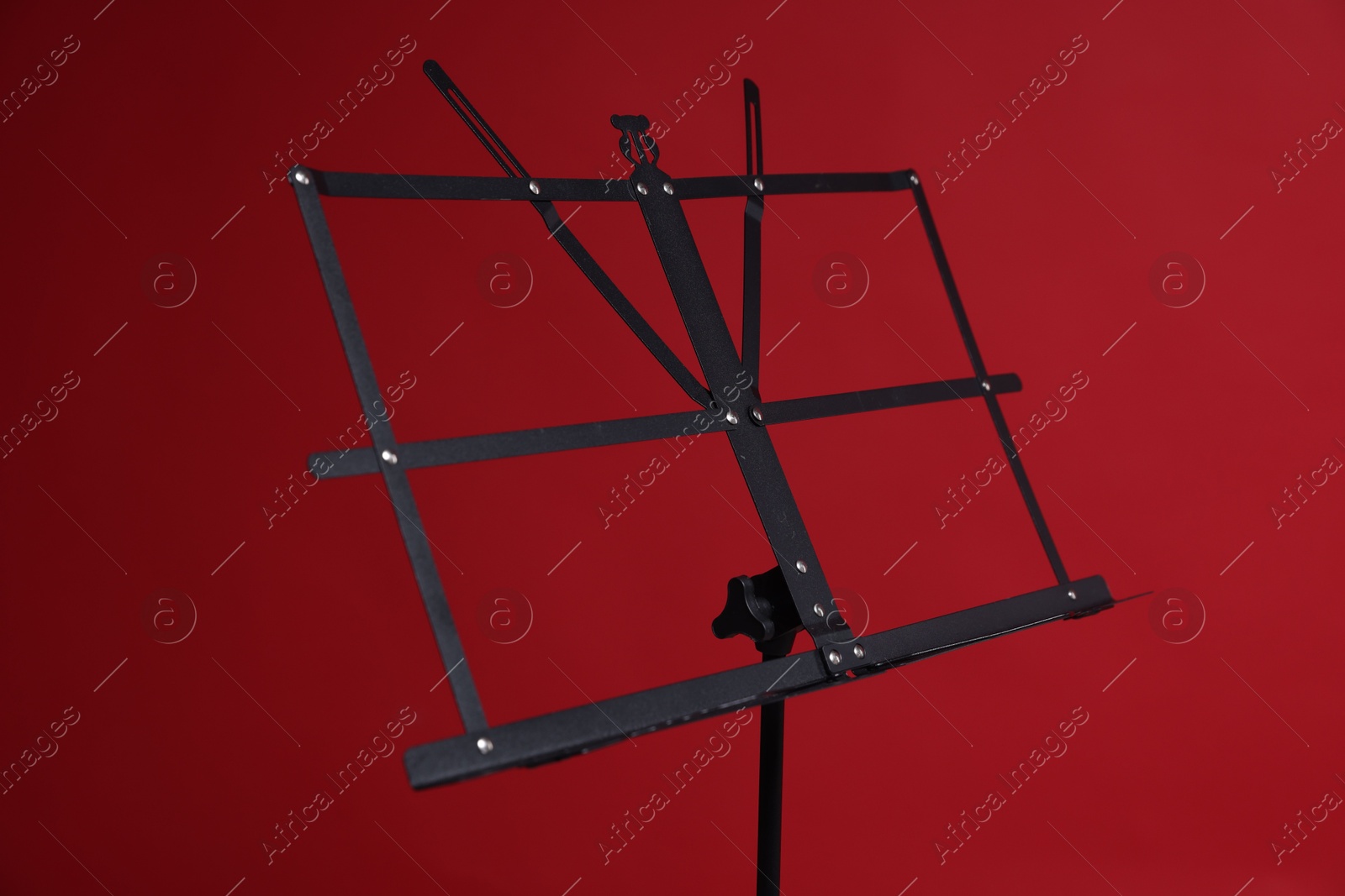 One empty note stand on red background, closeup Photo of One empty note stand on red background, closeup