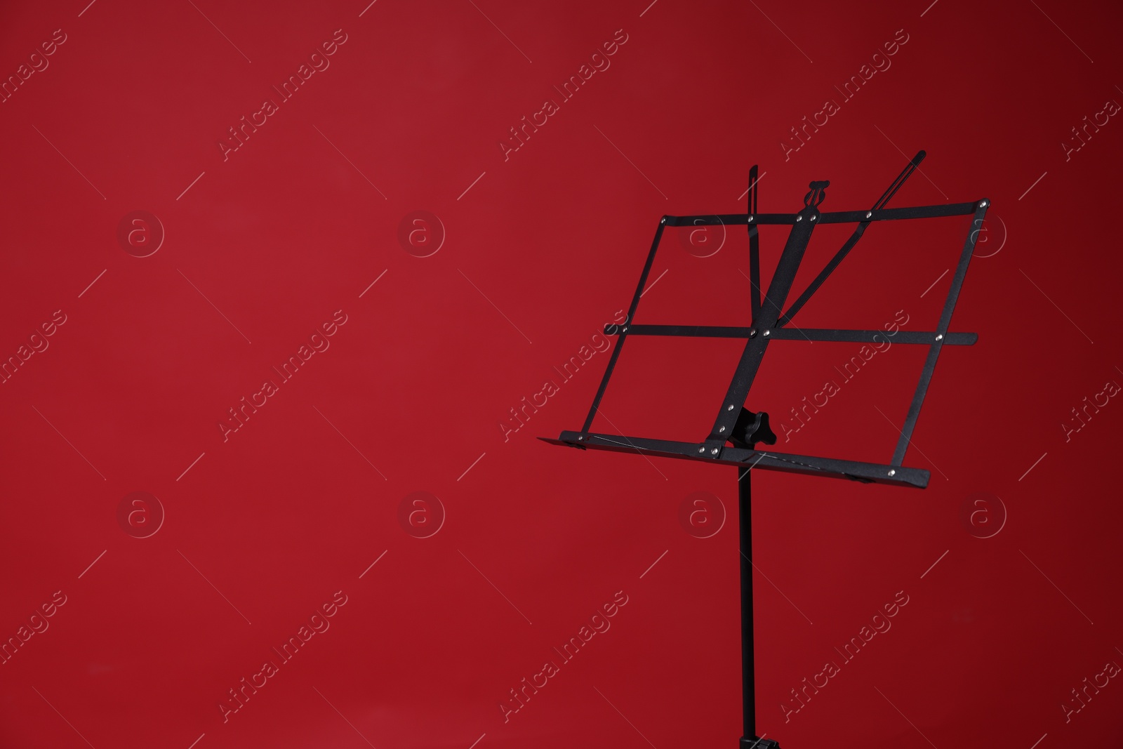 One empty note stand on red background, space for text Photo of One empty note stand on red background, space for text