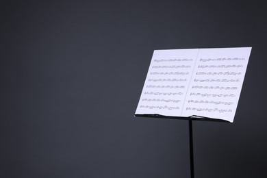 Photo of Note stand with music sheets on grey background, space for text
