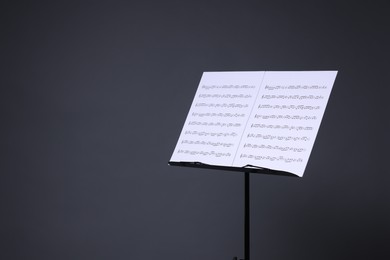Photo of Note stand with music sheets on grey background, space for text