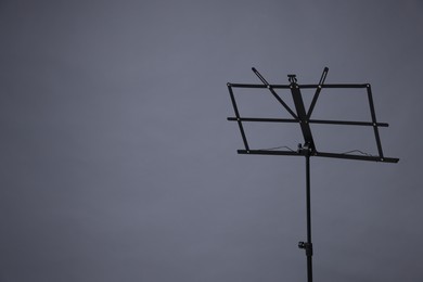 Photo of One empty note stand on grey background, space for text
