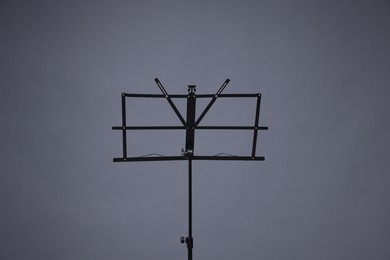 Photo of One empty note stand on grey background