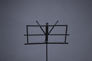 Photo of One empty note stand on grey background