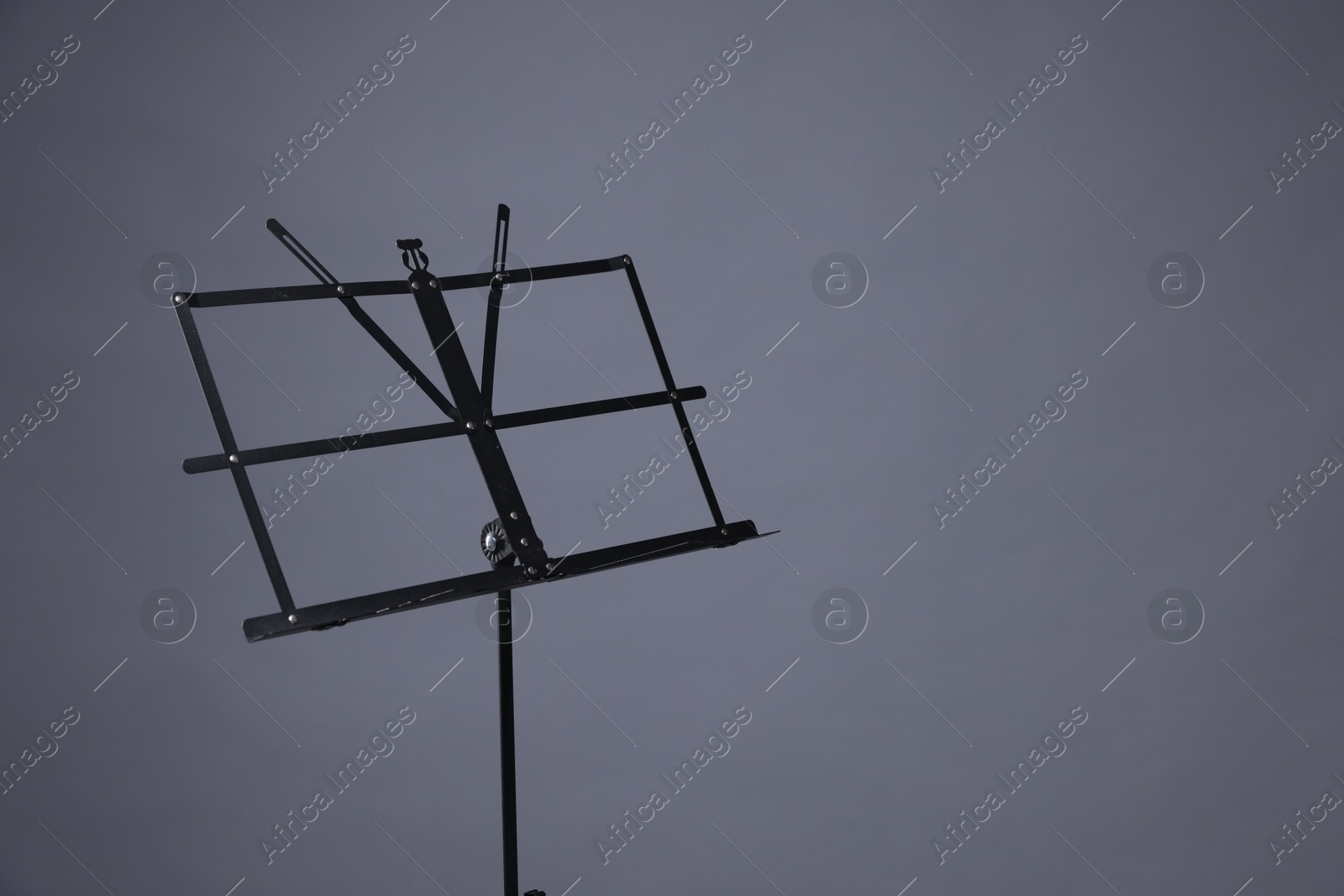 Photo of One empty note stand on grey background, space for text
