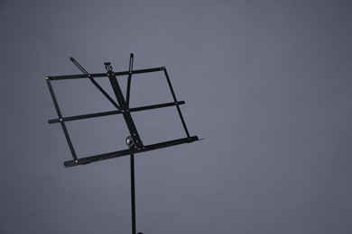 Photo of One empty note stand on grey background, space for text