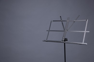 Photo of One empty note stand on grey background, space for text