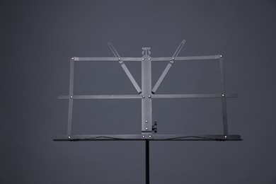 Photo of One empty note stand on grey background