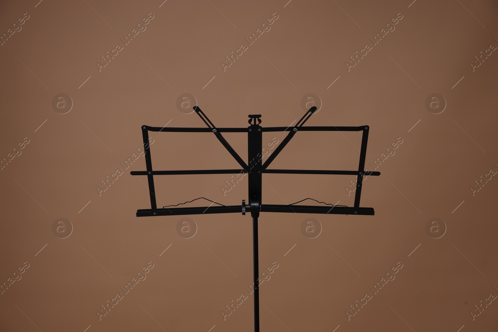 One empty note stand on dark beige background Photo of One empty note stand on dark beige background