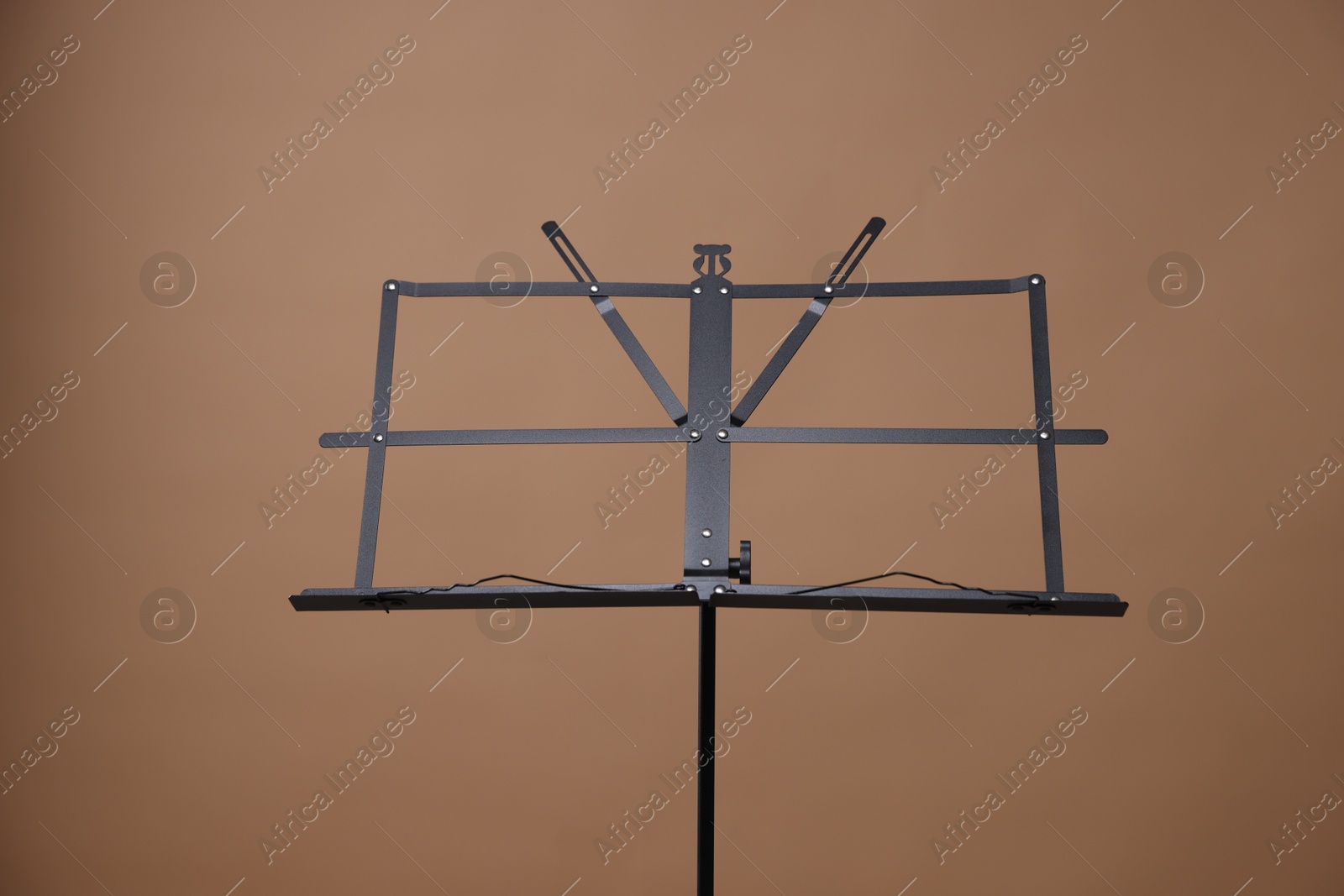 One empty note stand on dark beige background Photo of One empty note stand on dark beige background