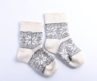 Photo of Pair of wool socks isolated on white, top view