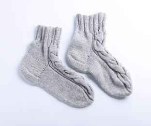 Photo of Pair of gray wool socks isolated on white, top view