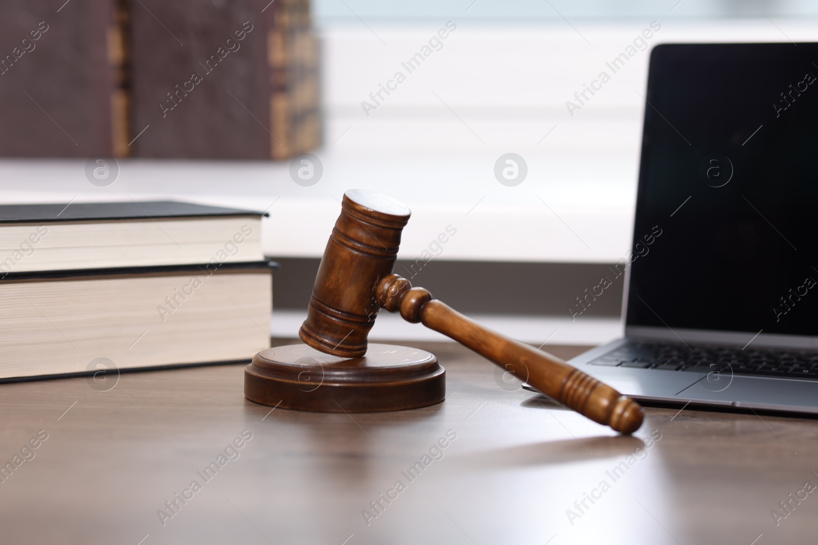 Judge. Laptop, gavel and books on wooden table in office Photo of Judge. Laptop, gavel and books on wooden table in office