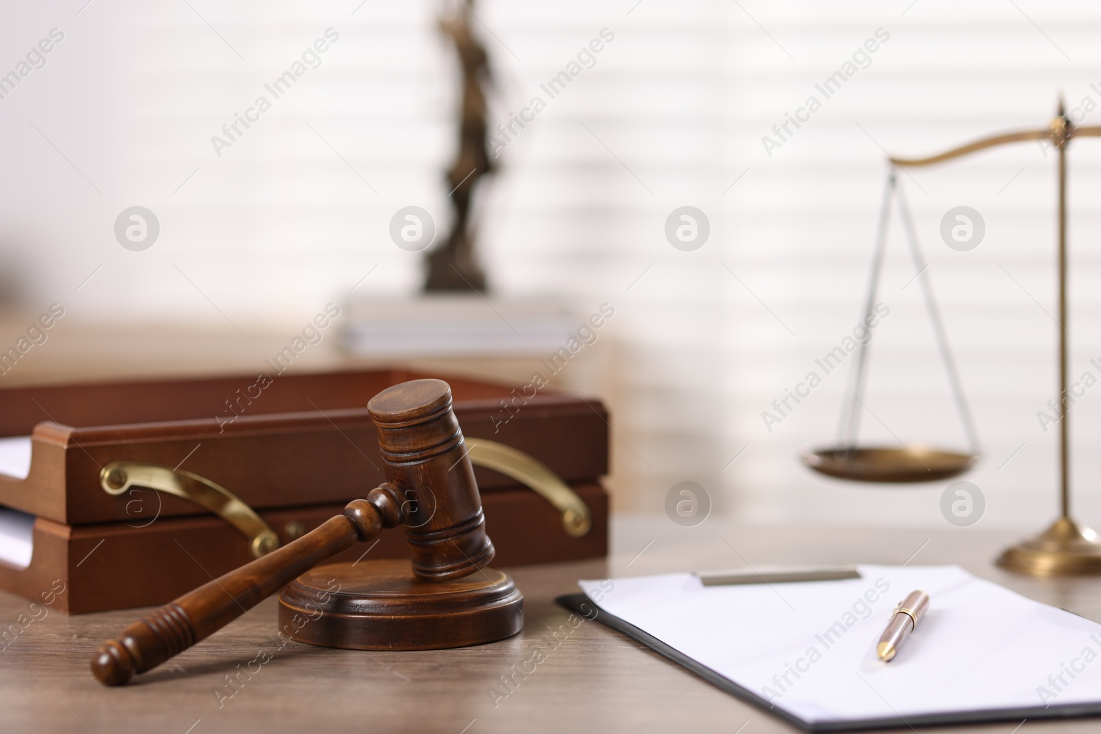 Judge. Gavel, scales, clipboard and pen on wooden table in office, selective focus Photo of Judge. Gavel, scales, clipboard and pen on wooden table in office, selective focus
