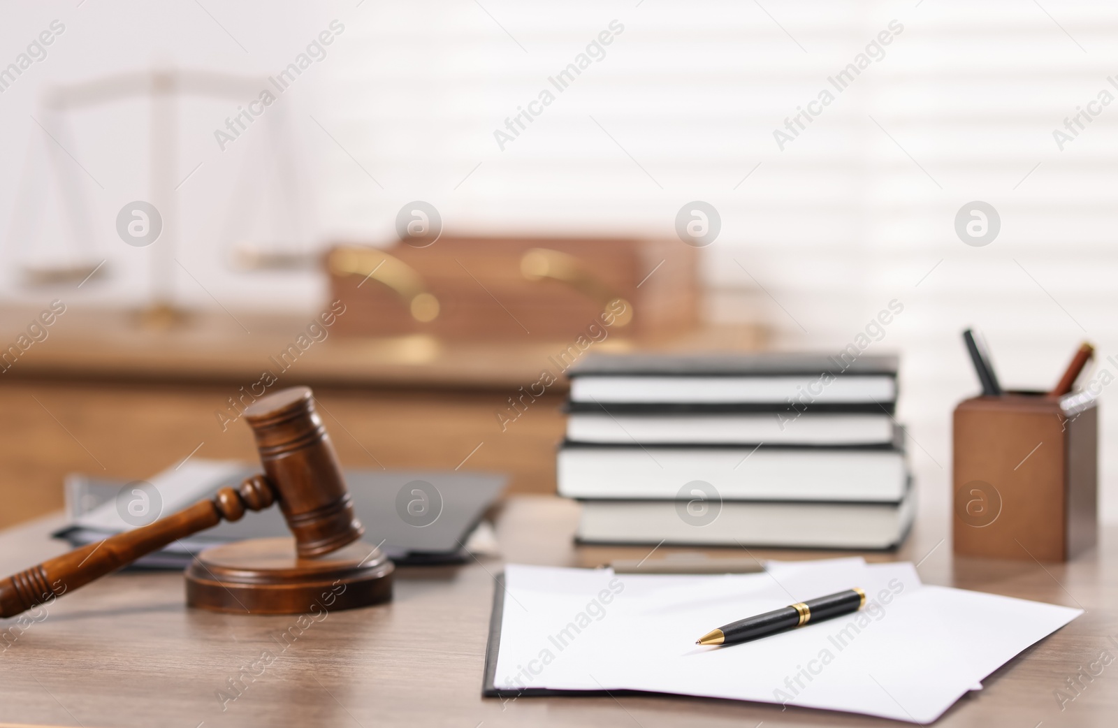Judge. Gavel, books, papers and pen on wooden table in office, selective focus Photo of Judge. Gavel, books, papers and pen on wooden table in office, selective focus