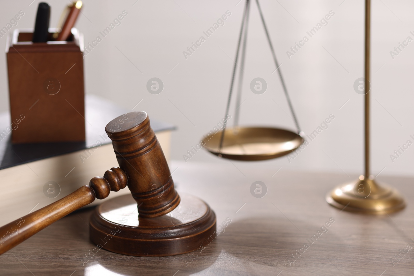Judge. Gavel and scales on wooden table in office, closeup Photo of Judge. Gavel and scales on wooden table in office, closeup