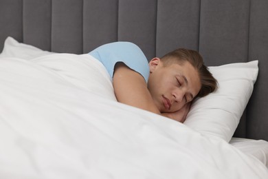 Photo of Man sleeping in comfortable bed at home