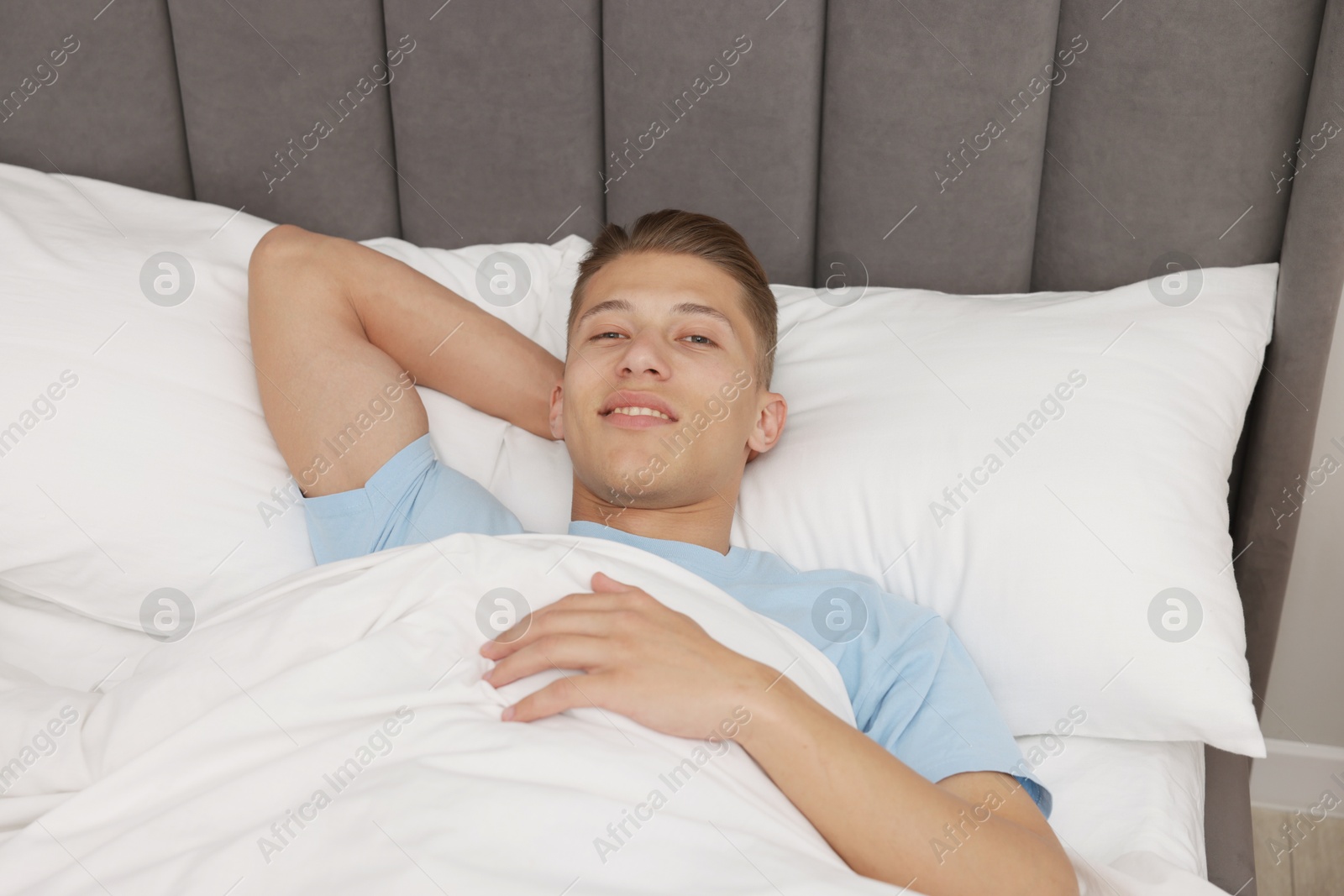 Man lying in comfortable bed at home, above view Photo of Man lying in comfortable bed at home, above view