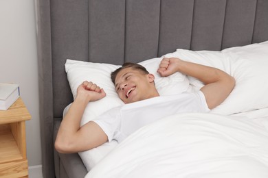 Photo of Man lying in comfortable bed at home
