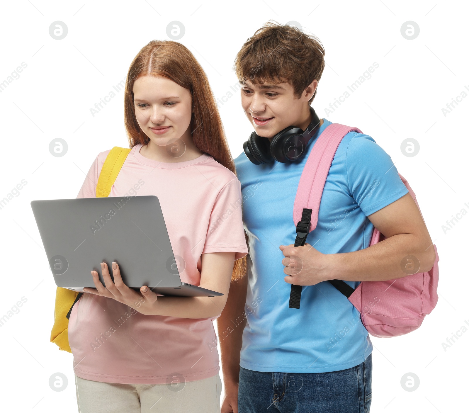 Teenage girl and boy with laptop on white background Photo of Teenage girl and boy with laptop on white background