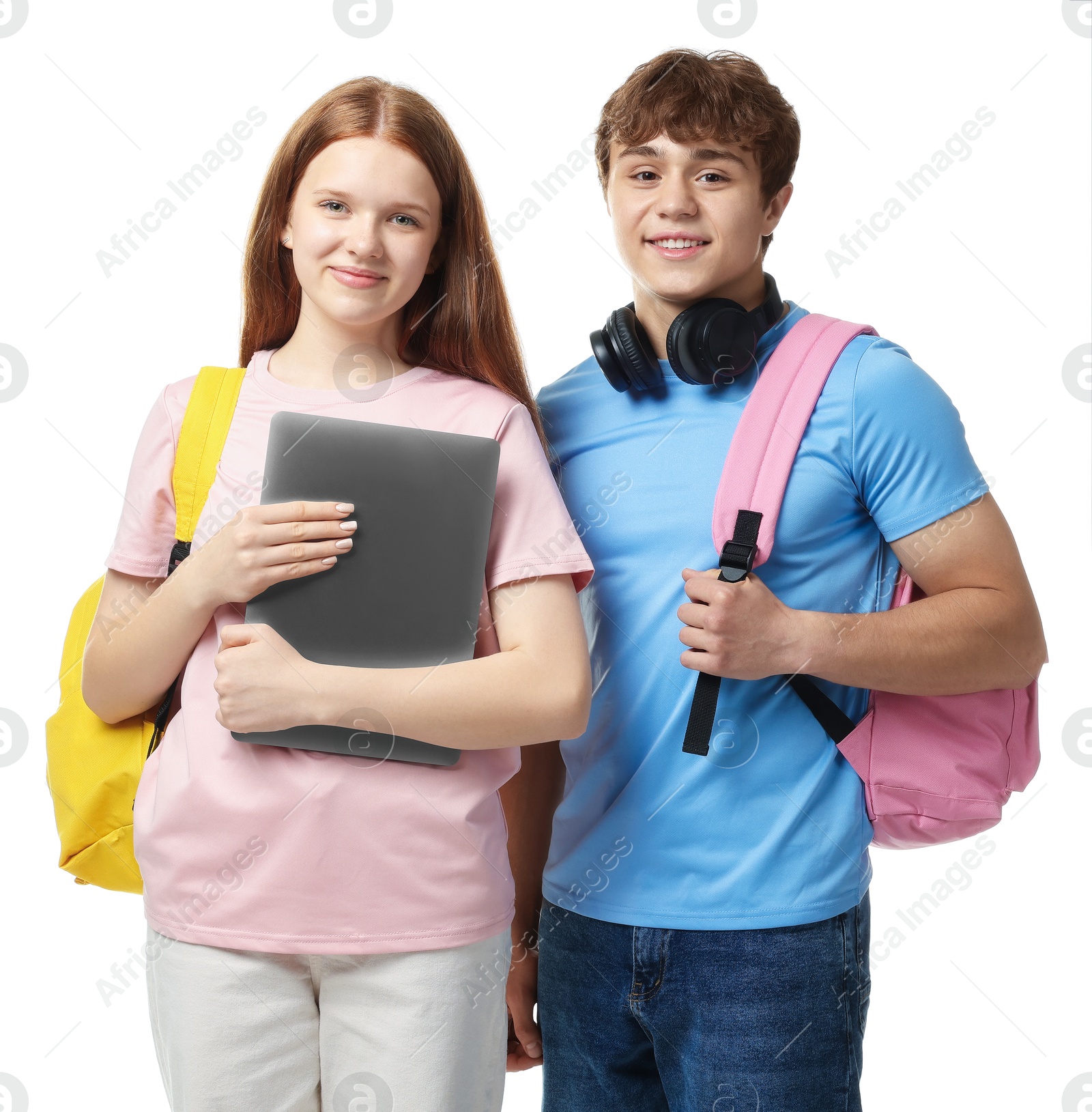 Teenage girl and boy with laptop on white background Photo of Teenage girl and boy with laptop on white background