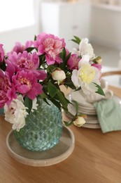 Photo of Dining table with beautiful flowers and dishware indoors, closeup. Interior design