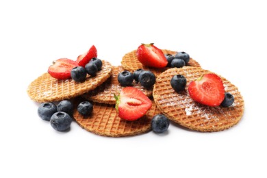 Photo of Tasty Dutch waffles (stroopwafels) and berries isolated on white