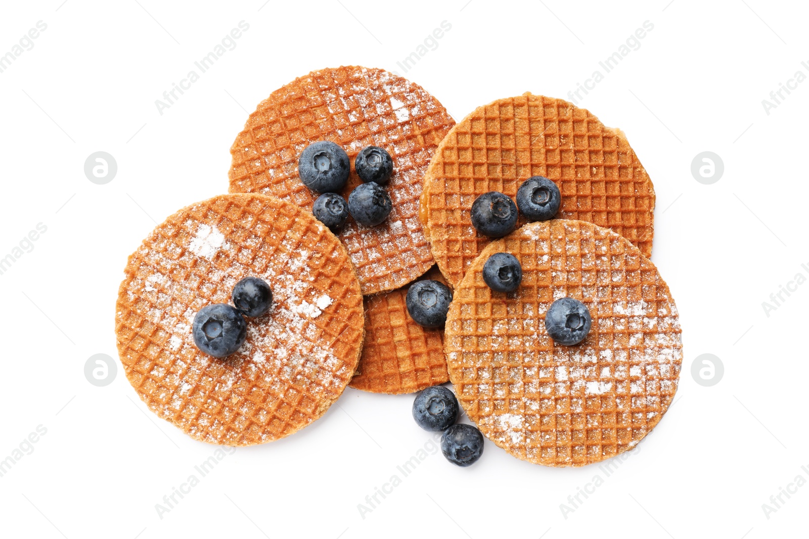 Tasty Dutch waffles (stroopwafels) and blueberries isolated on white, top view Photo of Tasty Dutch waffles (stroopwafels) and blueberries isolated on white, top view