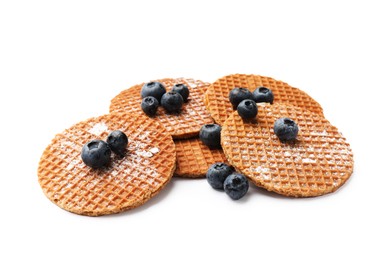 Photo of Tasty Dutch waffles (stroopwafels) and blueberries isolated on white
