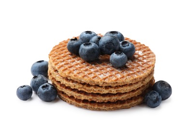 Photo of Tasty Dutch waffles (stroopwafels) and blueberries isolated on white