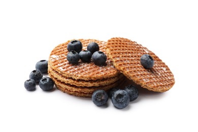 Photo of Tasty Dutch waffles (stroopwafels) and blueberries isolated on white