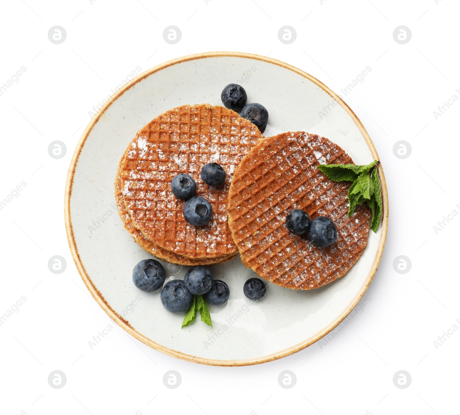 Tasty Dutch waffles (stroopwafels), mint and blueberries isolated on white, top view Photo of Tasty Dutch waffles (stroopwafels), mint and blueberries isolated on white, top view