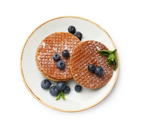 Photo of Tasty Dutch waffles (stroopwafels), mint and blueberries isolated on white, top view