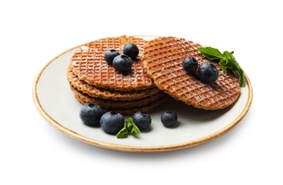 Photo of Tasty Dutch waffles (stroopwafels), mint and blueberries isolated on white