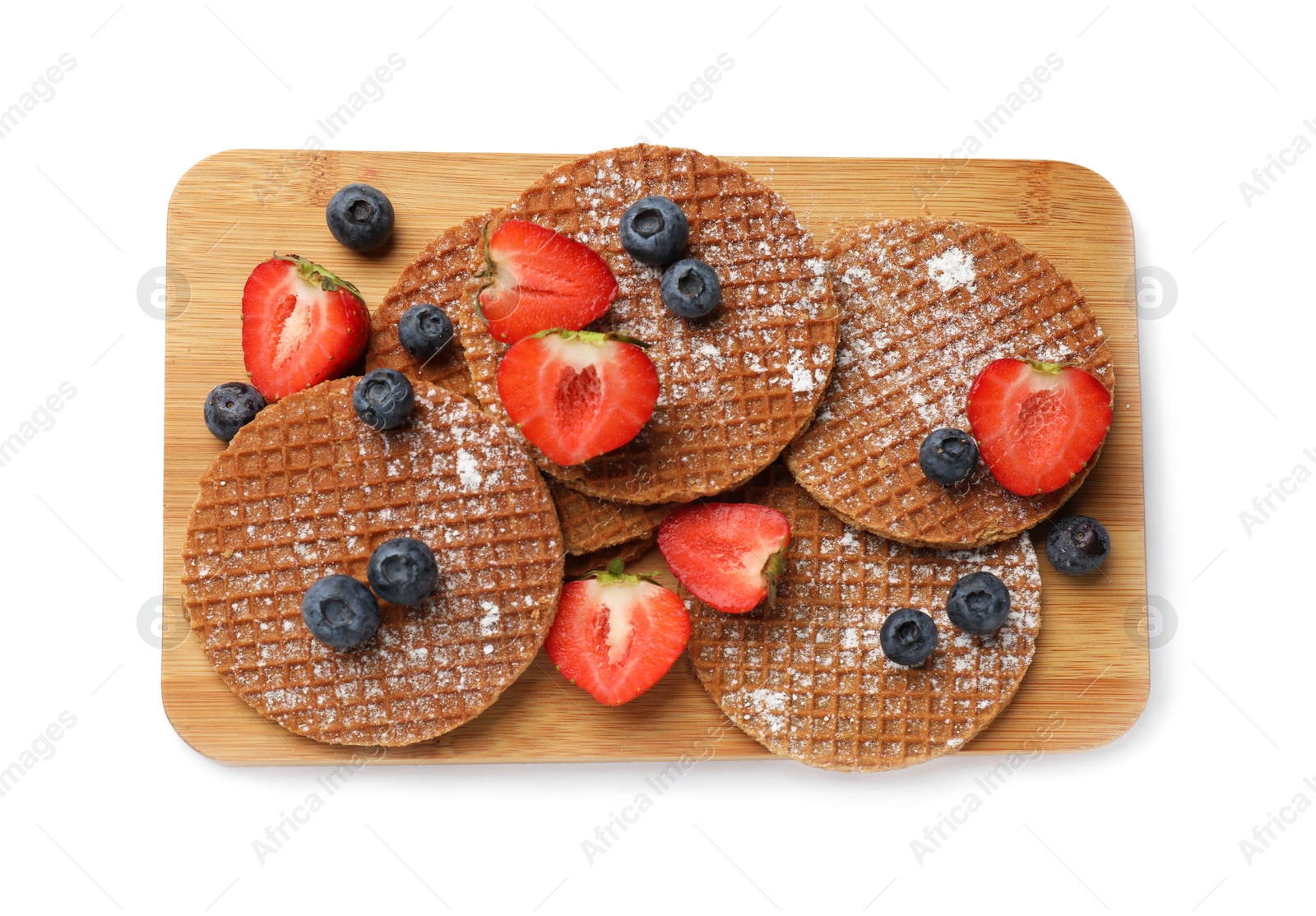 Tasty Dutch waffles (stroopwafels) and berries isolated on white, top view Photo of Tasty Dutch waffles (stroopwafels) and berries isolated on white, top view