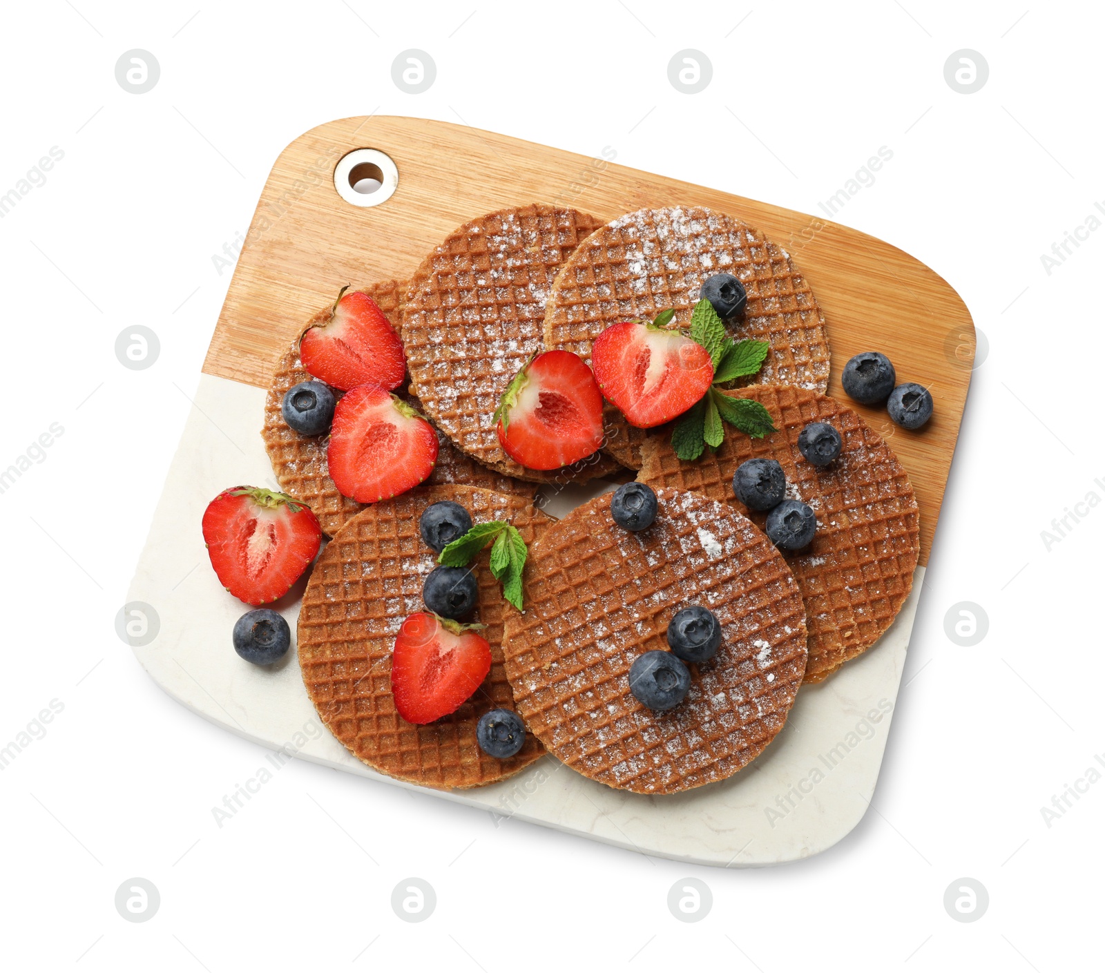 Tasty Dutch waffles (stroopwafels) and berries isolated on white, top view Photo of Tasty Dutch waffles (stroopwafels) and berries isolated on white, top view