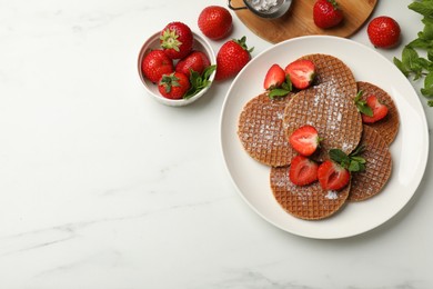 Photo of Tasty Dutch waffles (stroopwafels), mint and strawberries on white marble table, flat lay. Space for text