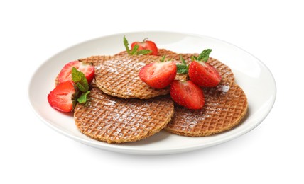 Photo of Tasty Dutch waffles (stroopwafels), mint and strawberries isolated on white