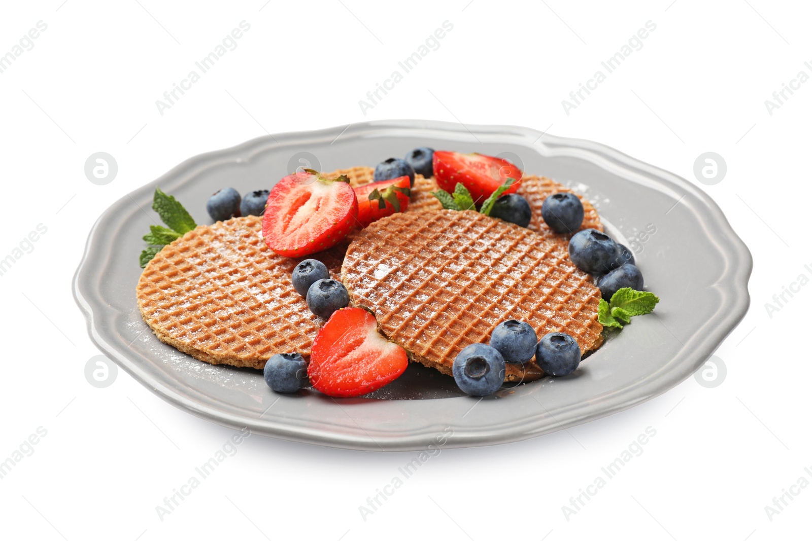 Tasty Dutch waffles (stroopwafels), mint and berries isolated on white Photo of Tasty Dutch waffles (stroopwafels), mint and berries isolated on white