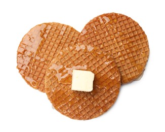 Photo of Tasty Dutch waffles (stroopwafels) with honey and butter cube isolated on white, top view