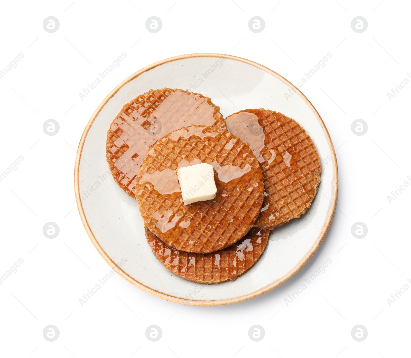 Tasty Dutch waffles (stroopwafels) with honey and butter cube isolated on white, top view Photo of Tasty Dutch waffles (stroopwafels) with honey and butter cube isolated on white, top view