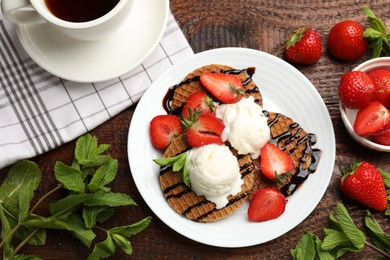 Photo of Tasty Dutch waffles (stroopwafels) with strawberries, ice cream and chocolate sauce on wooden table, flat lay