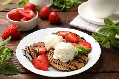 Photo of Tasty Dutch waffles (stroopwafels) with strawberries, ice cream and chocolate sauce on wooden table, closeup