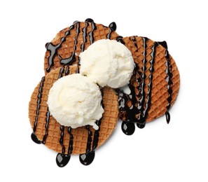 Photo of Tasty Dutch waffles (stroopwafels) with ice cream and chocolate sauce isolated on white, top view