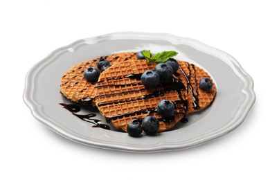 Photo of Tasty Dutch waffles (stroopwafels) with blueberries and chocolate sauce isolated on white