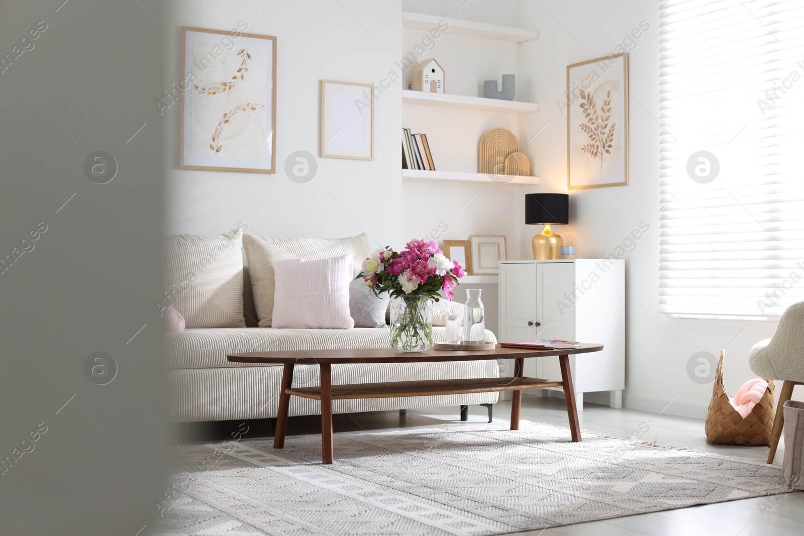 Bouquet of beautiful peonies and water on coffee table indoors. Interior design Photo of Bouquet of beautiful peonies and water on coffee table indoors. Interior design